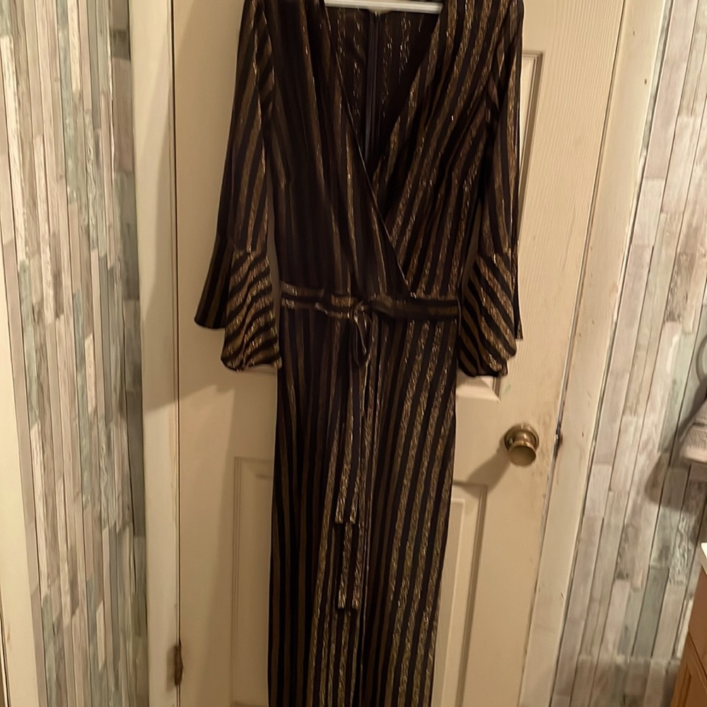 Size 14/16 gold and black one piece jumpsuit with attached shorts. Never worn.